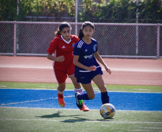Middle-school-aged Alison playing soccer
